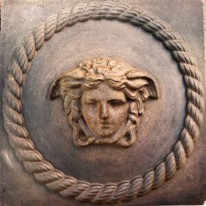 Finished weathered concrete Medusa wall relief with a rope-style border