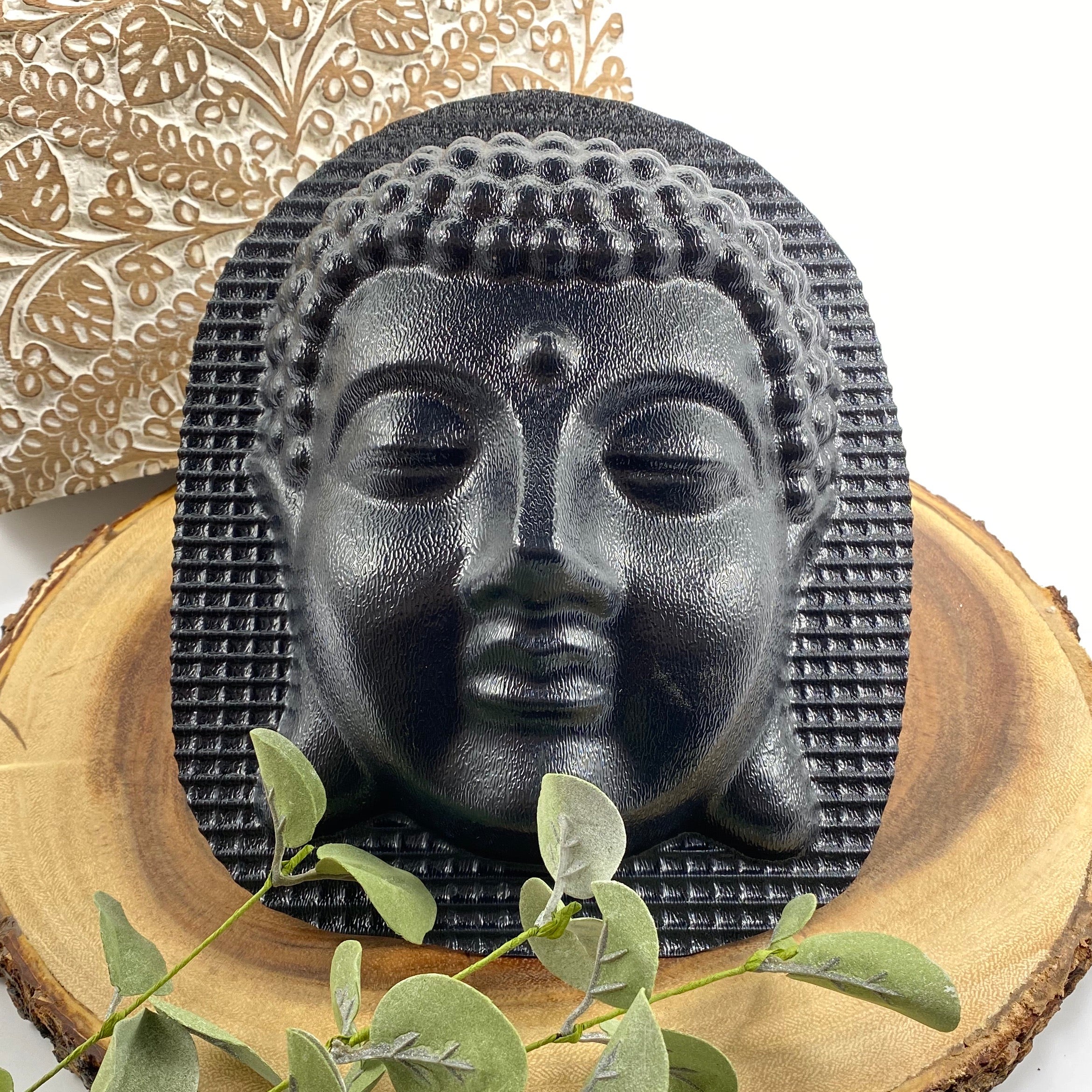 image 932a5c4b 3564 40c9 aed1 d39bab1032b8.jpg Finished dark concrete Buddha head wall relief styled with foliage