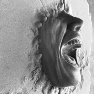 Gray cast concrete face through the wall relief protruding from a wall surface